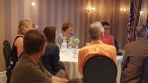 Scholars sit with family during the Marquette West Rotary meeting.