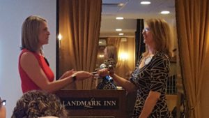 Passing off the gavel during the Marquette West Rotary meeting.